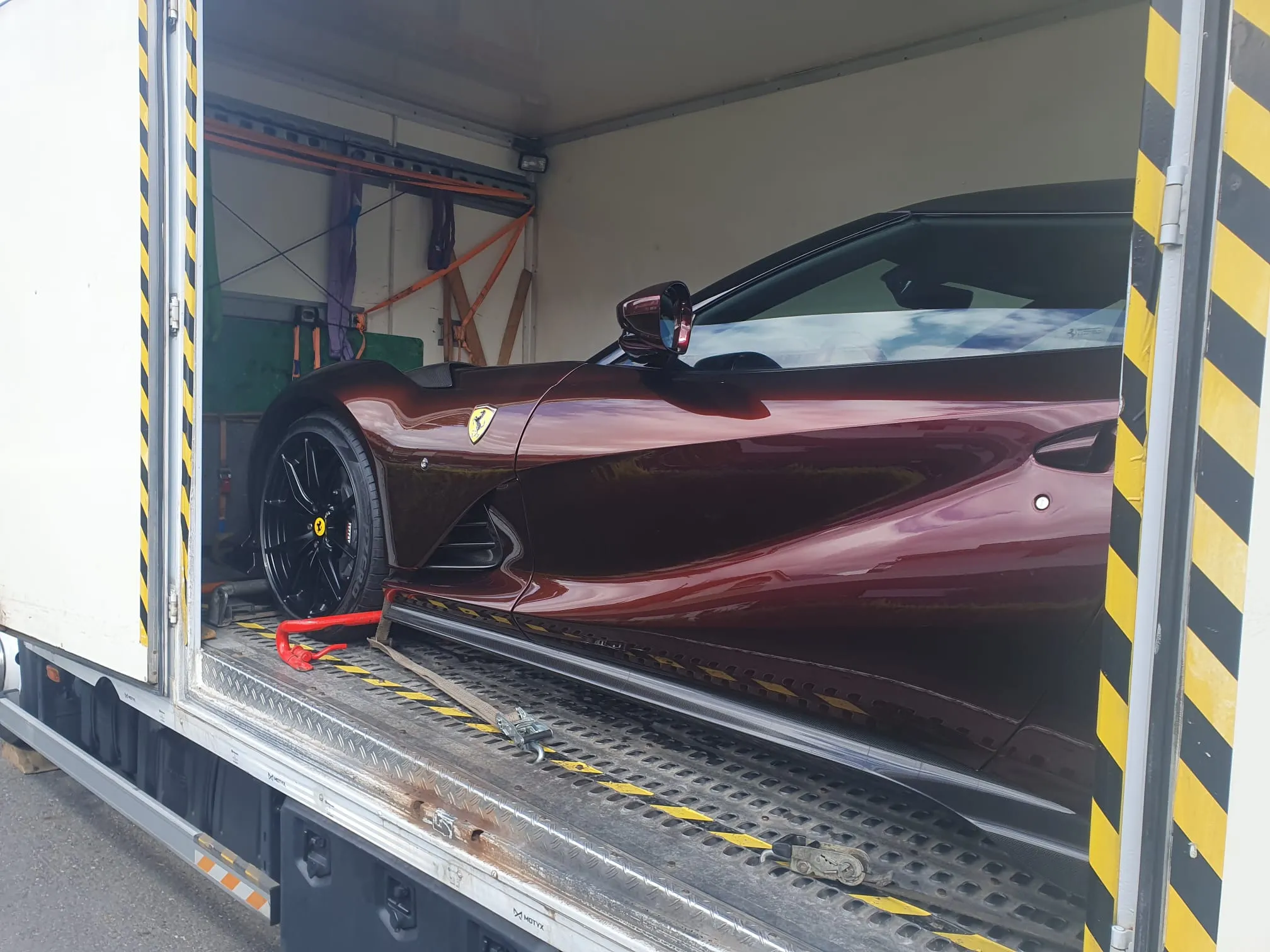 Ferrari 812 bordeaux ancorata nel furgone chiuso